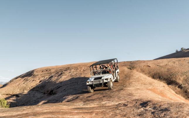 Gabriel driving a Hummer tour descending slickrock on Hells Revenge