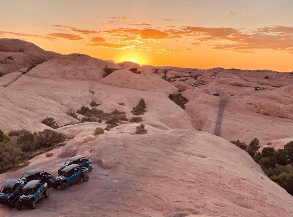 UTV's on the petrified dunes of Hell's Revenge at sunset 